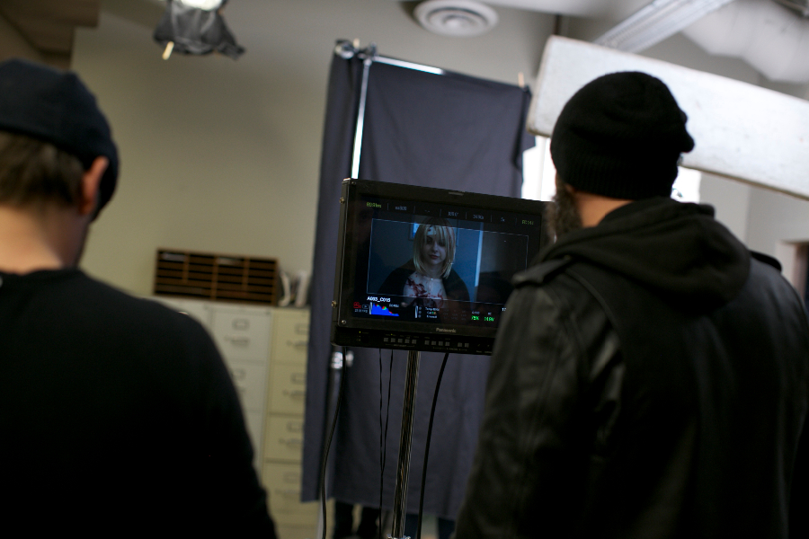 Director Erik Boccio, Producer Damian Lea look on at Pandie Suicide on the monitor